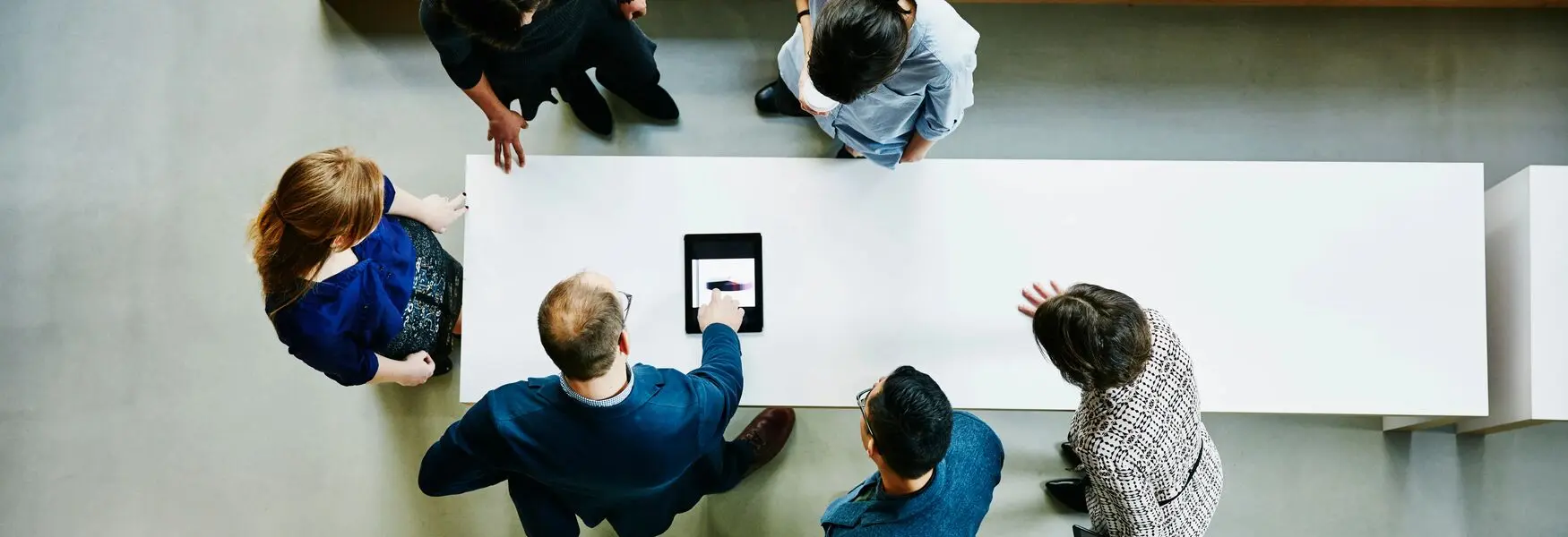 people-standing-around-a-table