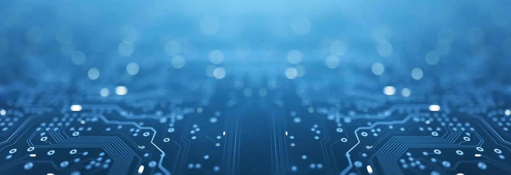 Close-up of a blue electronic circuit board with glowing lines and dots, symbolizing technology and connectivity.