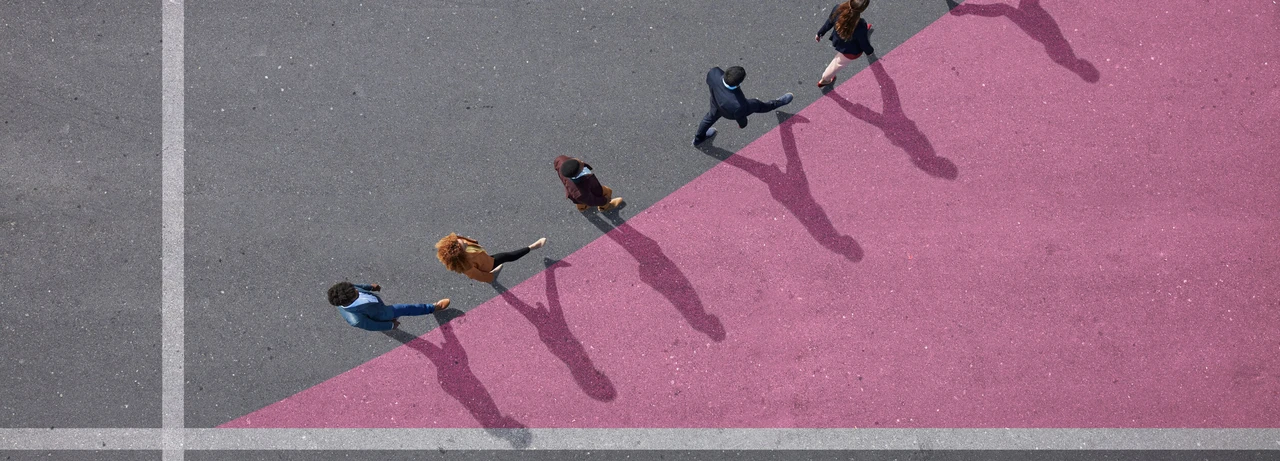 Group of young adults, photographed from above, on various painted tarmac surface, at sunrise.