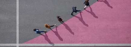 Group of young adults, photographed from above, on various painted tarmac surface, at sunrise.