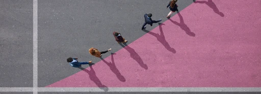 Group of young adults, photographed from above, on various painted tarmac surface, at sunrise.