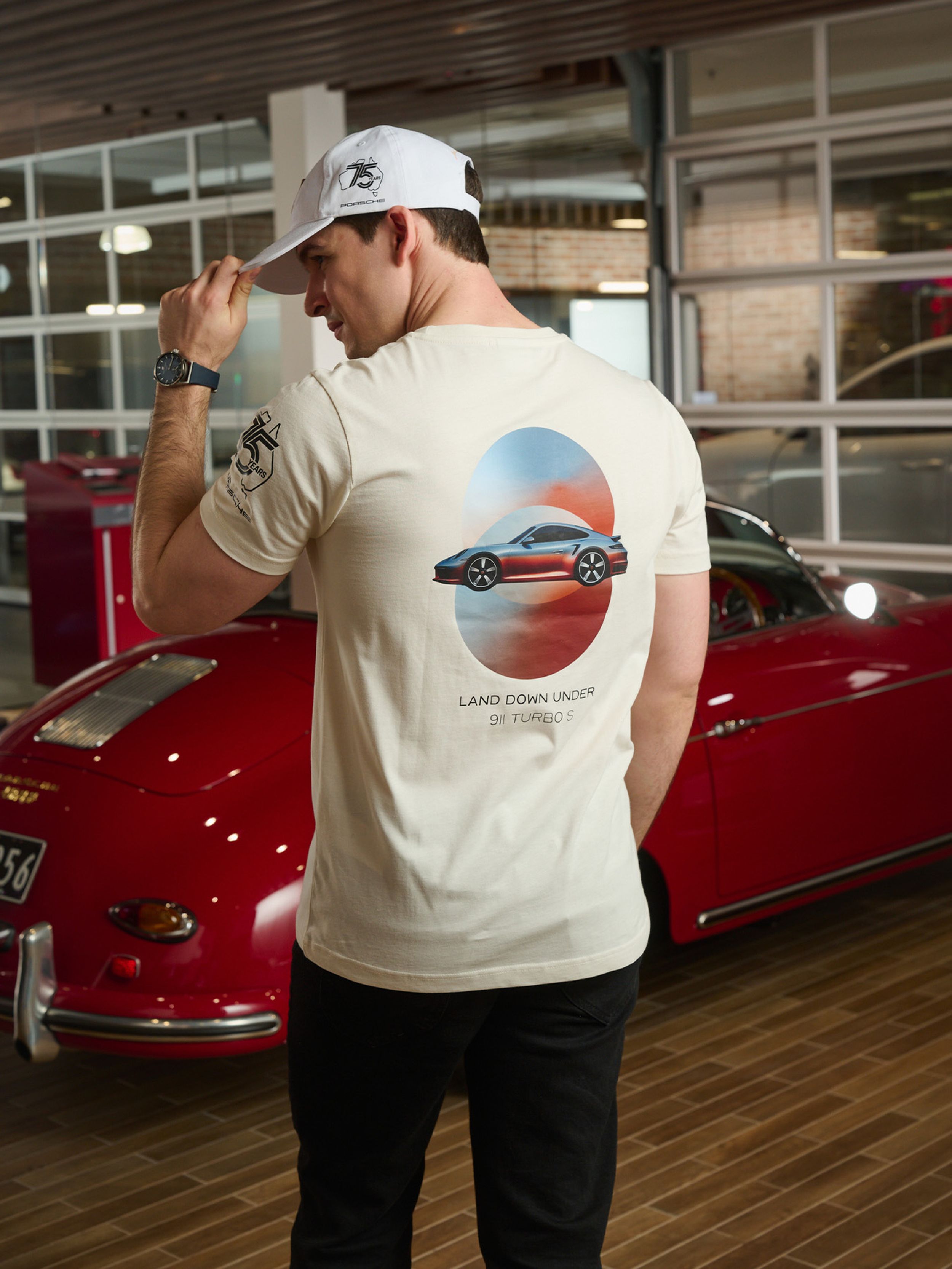 A man wearing 75 years Porsche Australia apparel.