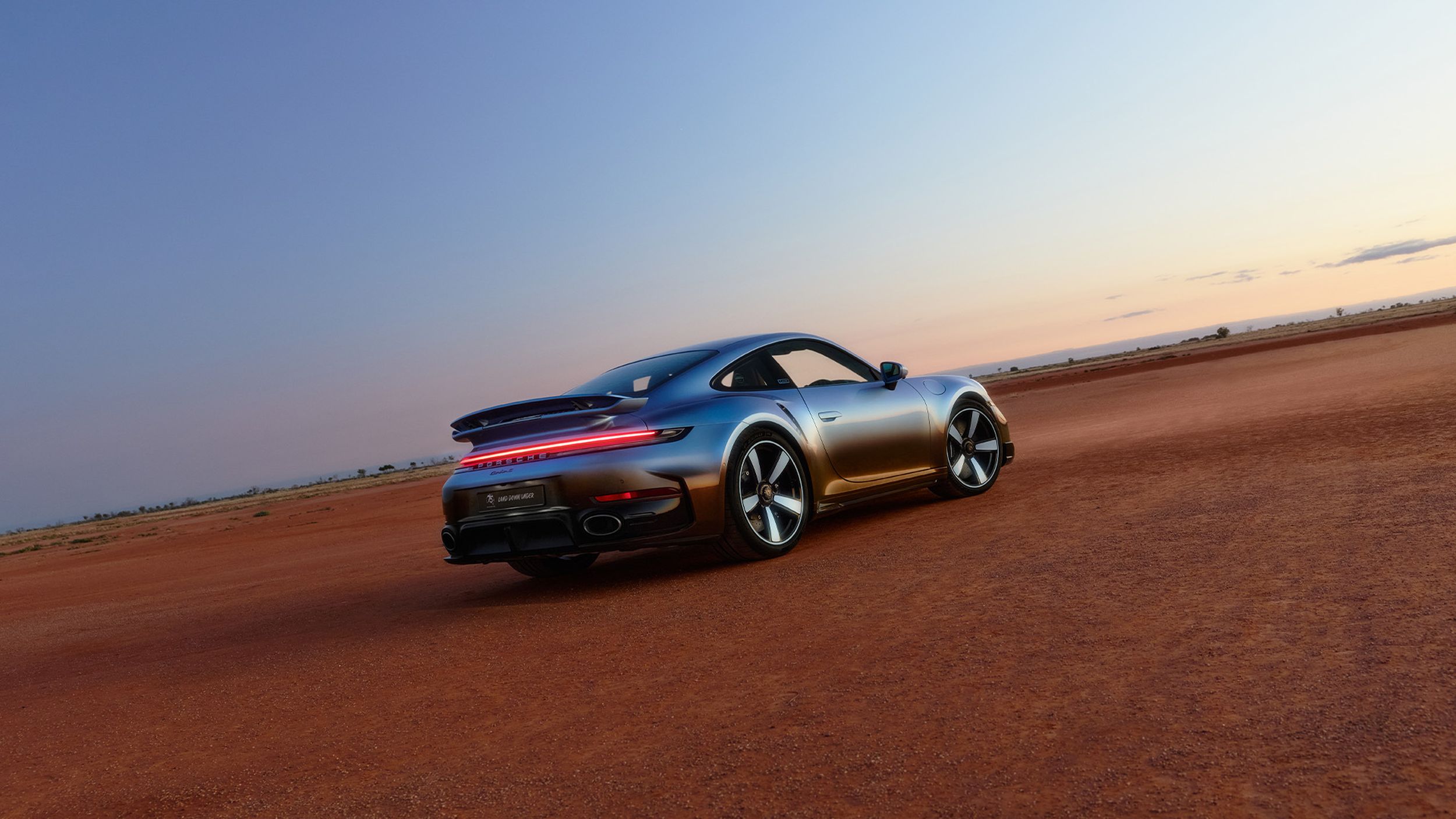 Side back shot of the 911 Turbo S Land Down Under in the outback.