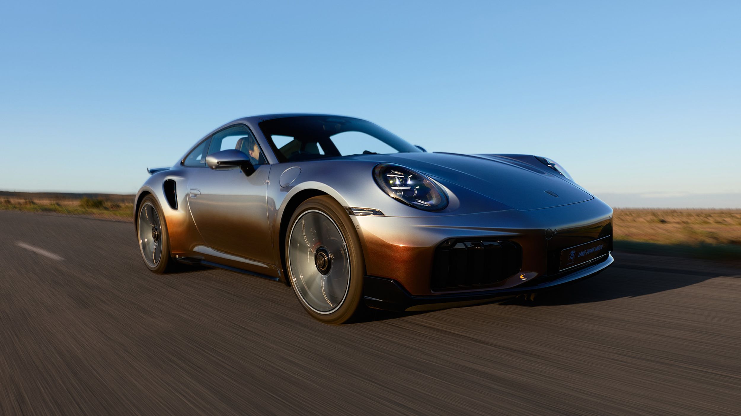Frontal side shot of the 911 Turbo S Land Down Under while driving.