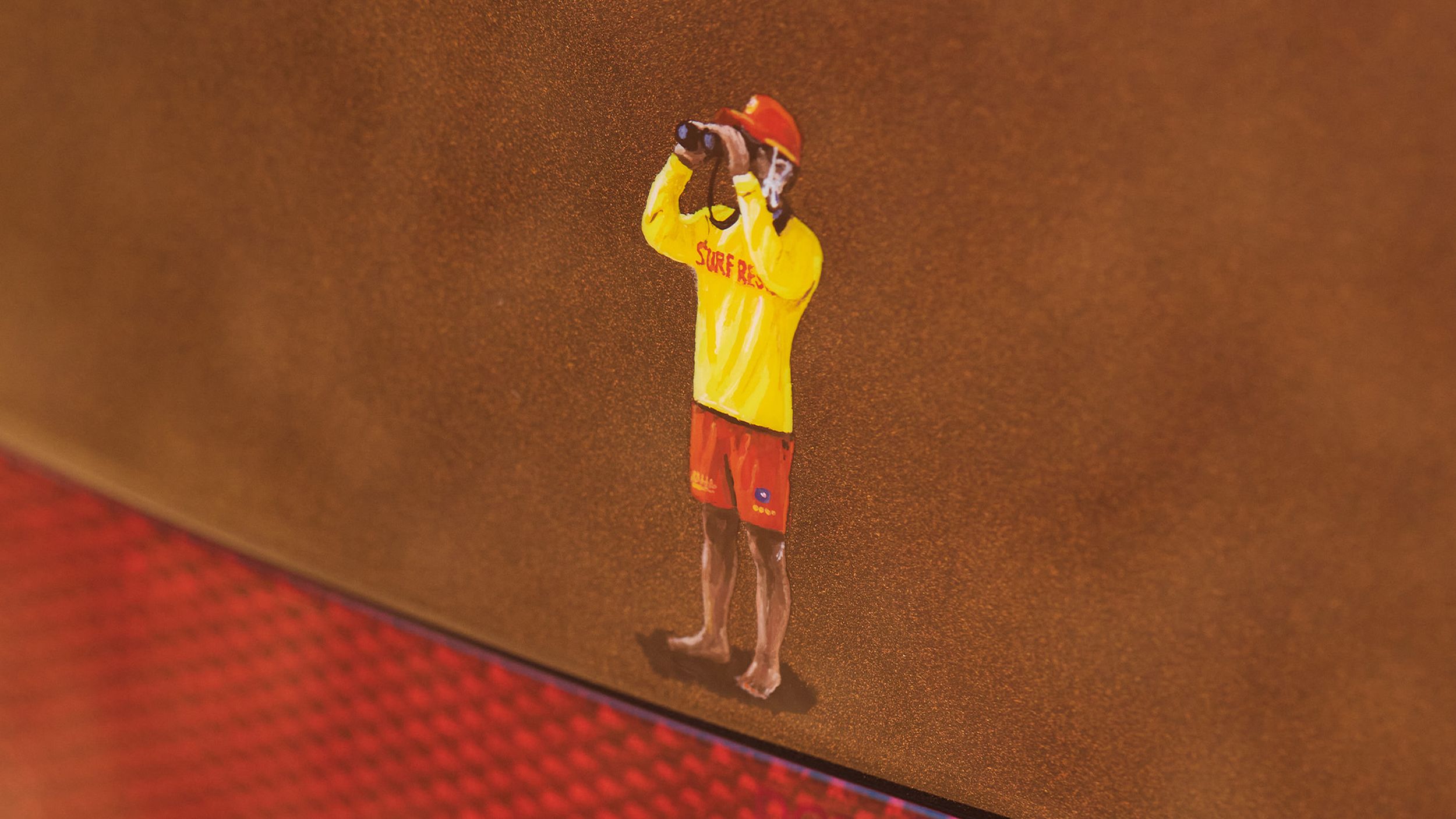 Decal of a man with binoculars wearing surf rescue apparel.