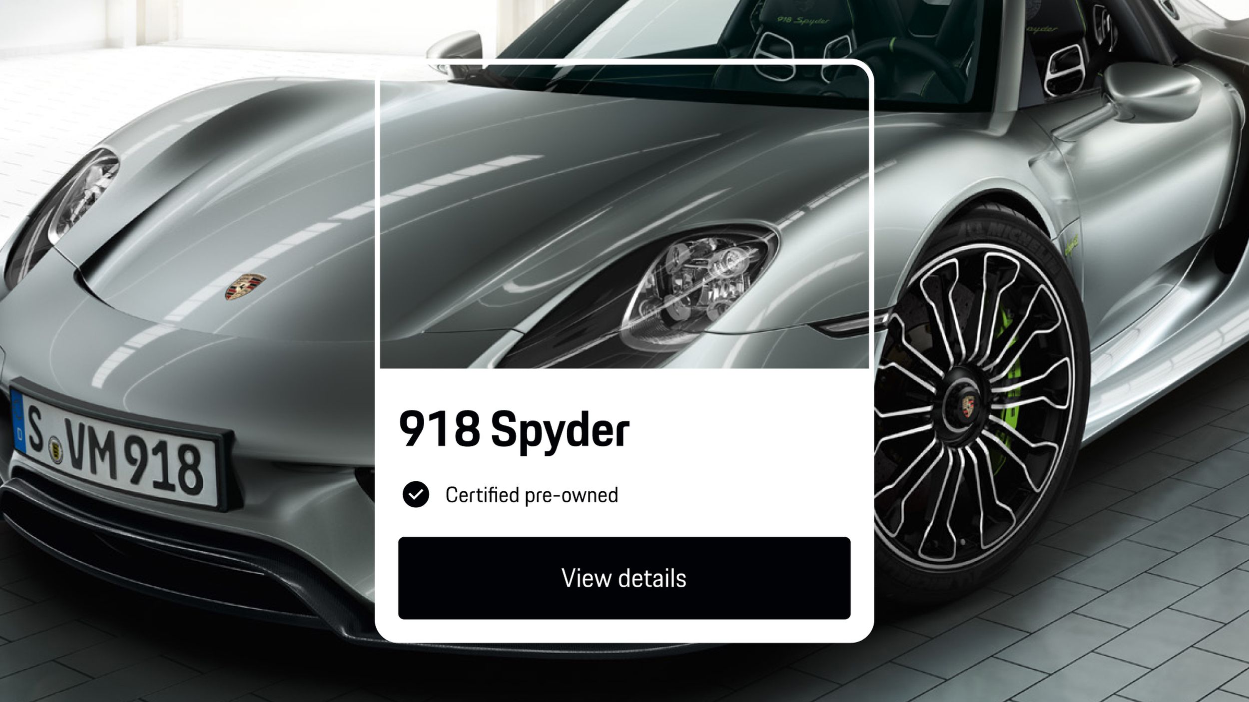 App view showing silver Porsche 918 Spyder, certified pre-owned, with black ‘View details’ button displayed below.