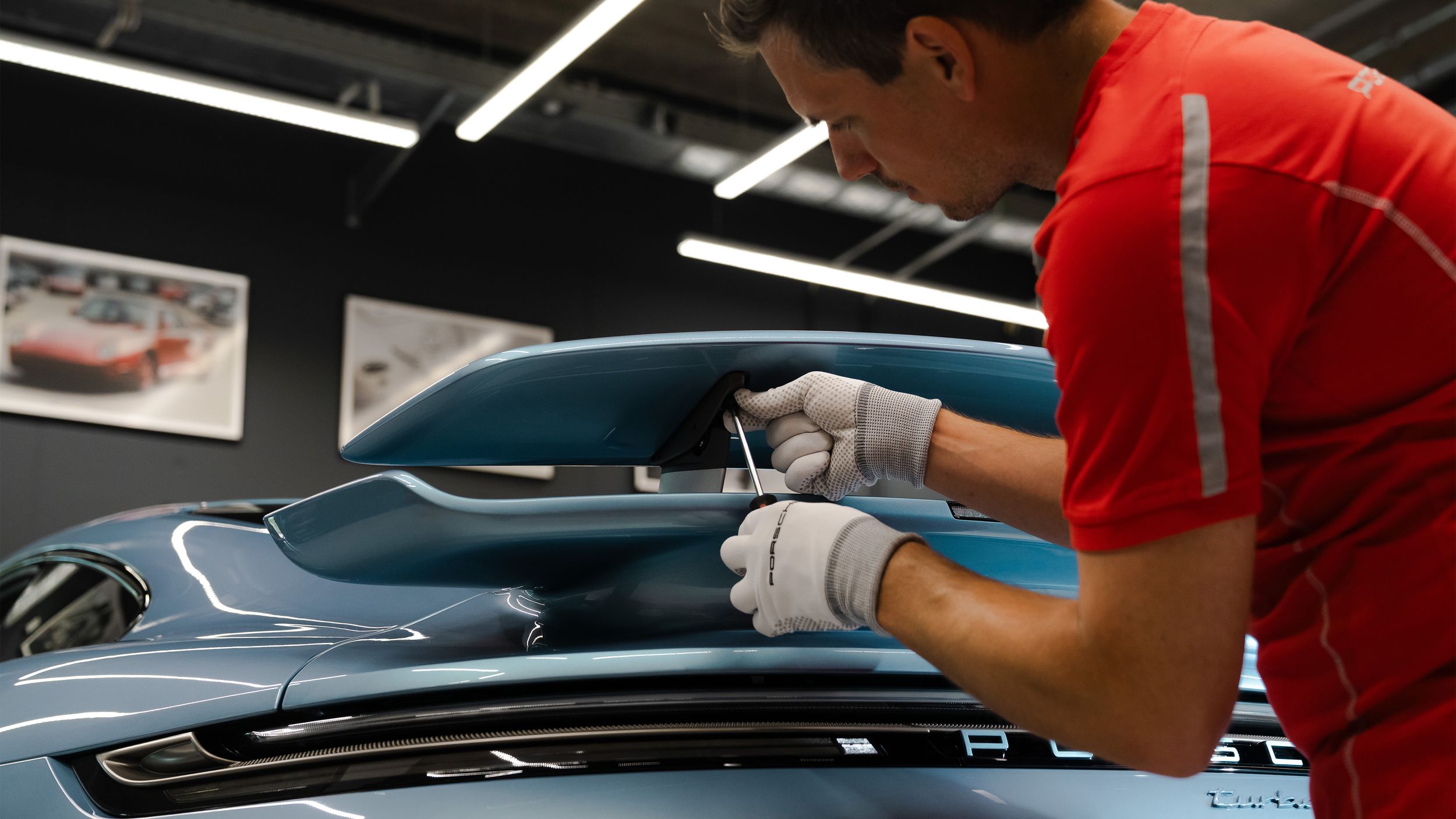 Porsche mechanic working on the rear spoiler of the 911 Turbo S Sonderwunsch commission.