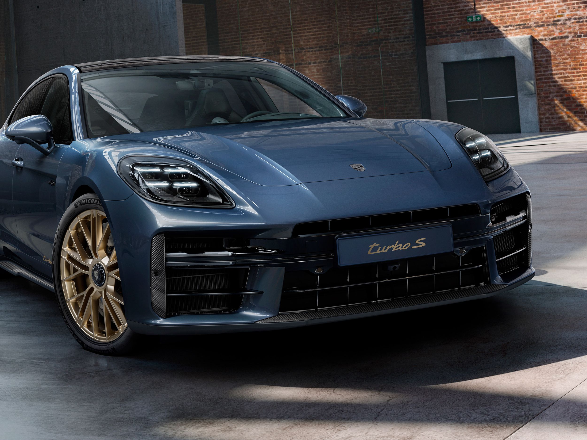 Front view of the front of the Porsche Exclusive Manufaktur Panamera Turbo S E-Hybrid in Yachting Blue Metallic with Aerokit Carbon.