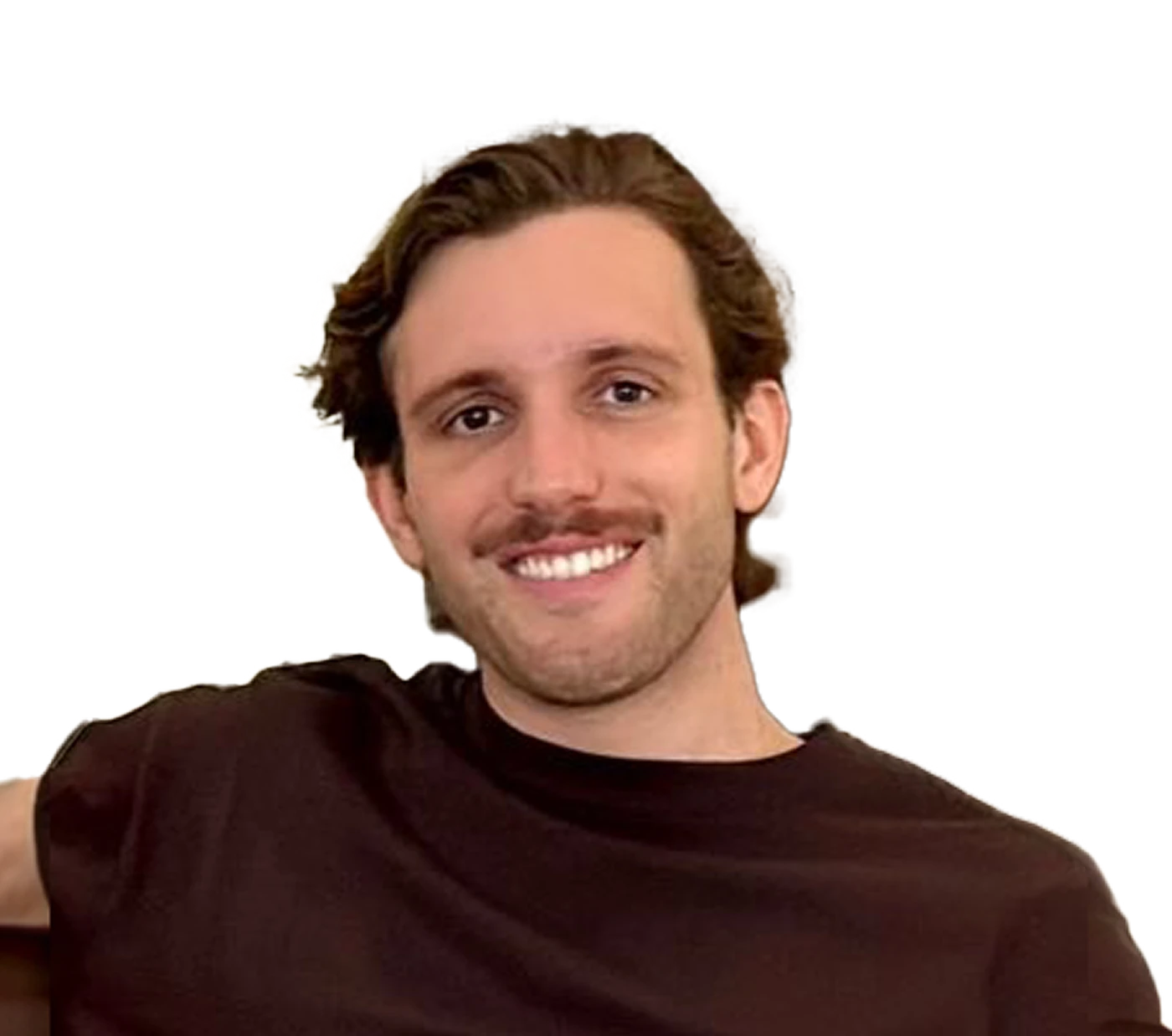 Smiling man with wavy hair and a beard, wearing a black shirt, against a plain background.