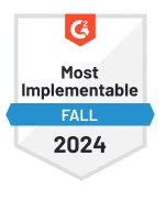 G2 badge titled "Most Implementable" for Fall 2024, featuring a red hexagon and blue banner design.