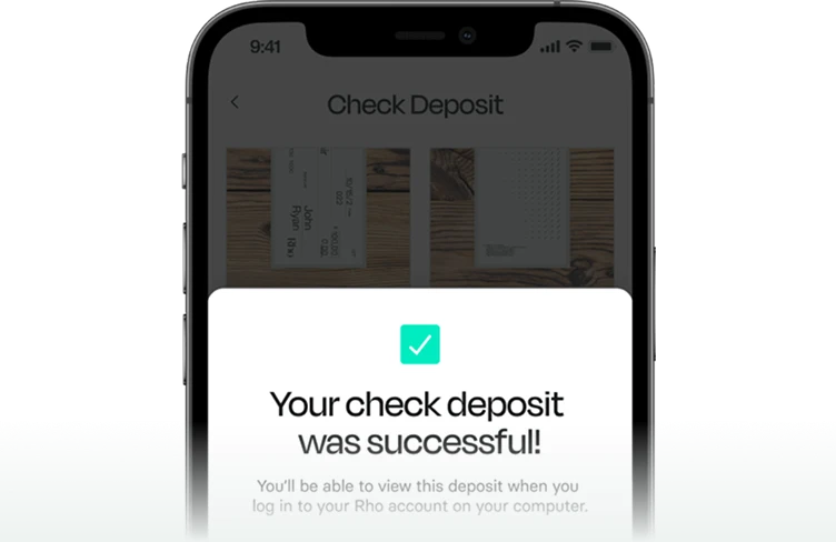 A smartphone screen displays a confirmation message: "Your check deposit was successful!" with check images in the background.