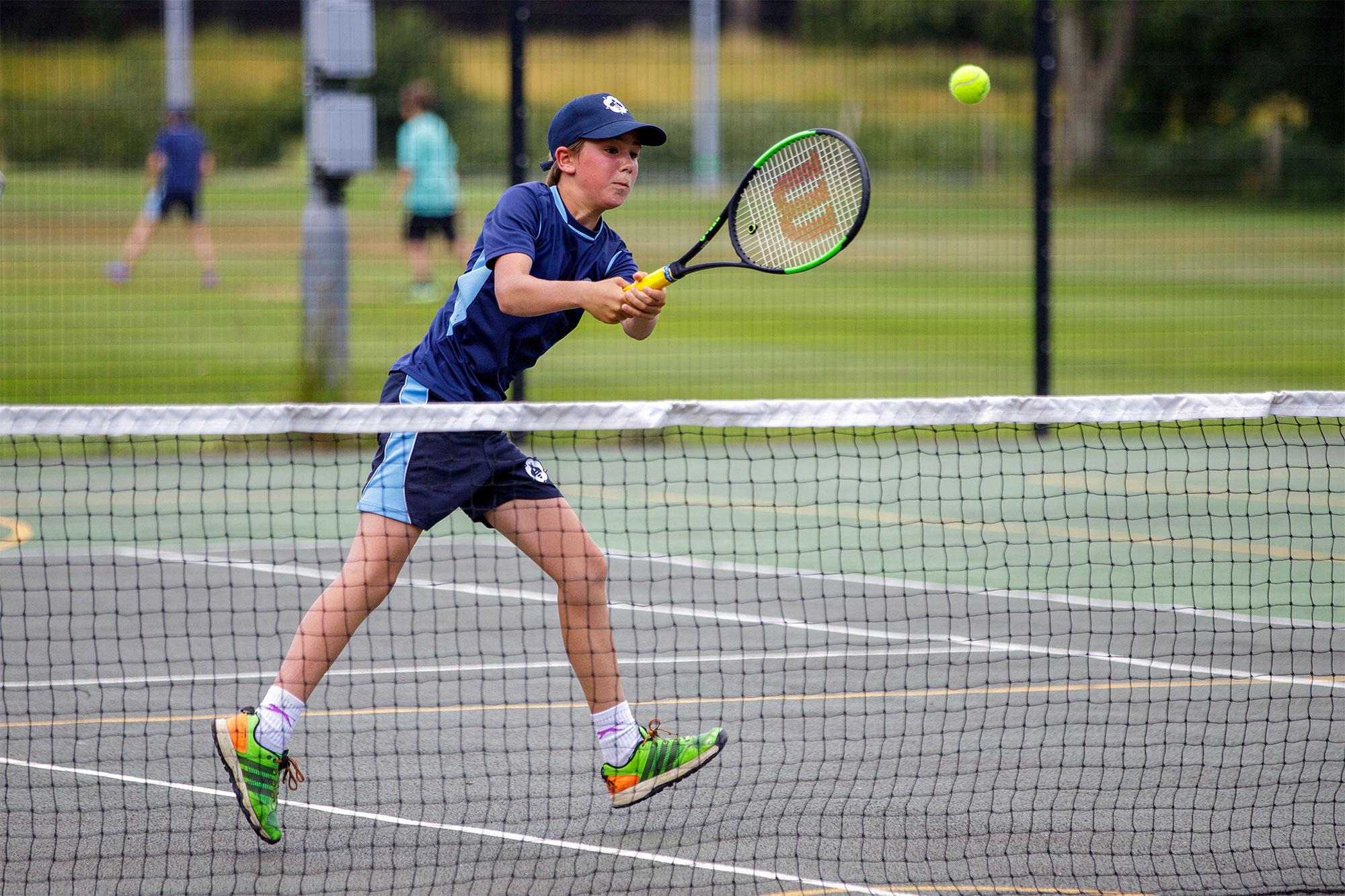 Bedales Prep student playing tennis on court