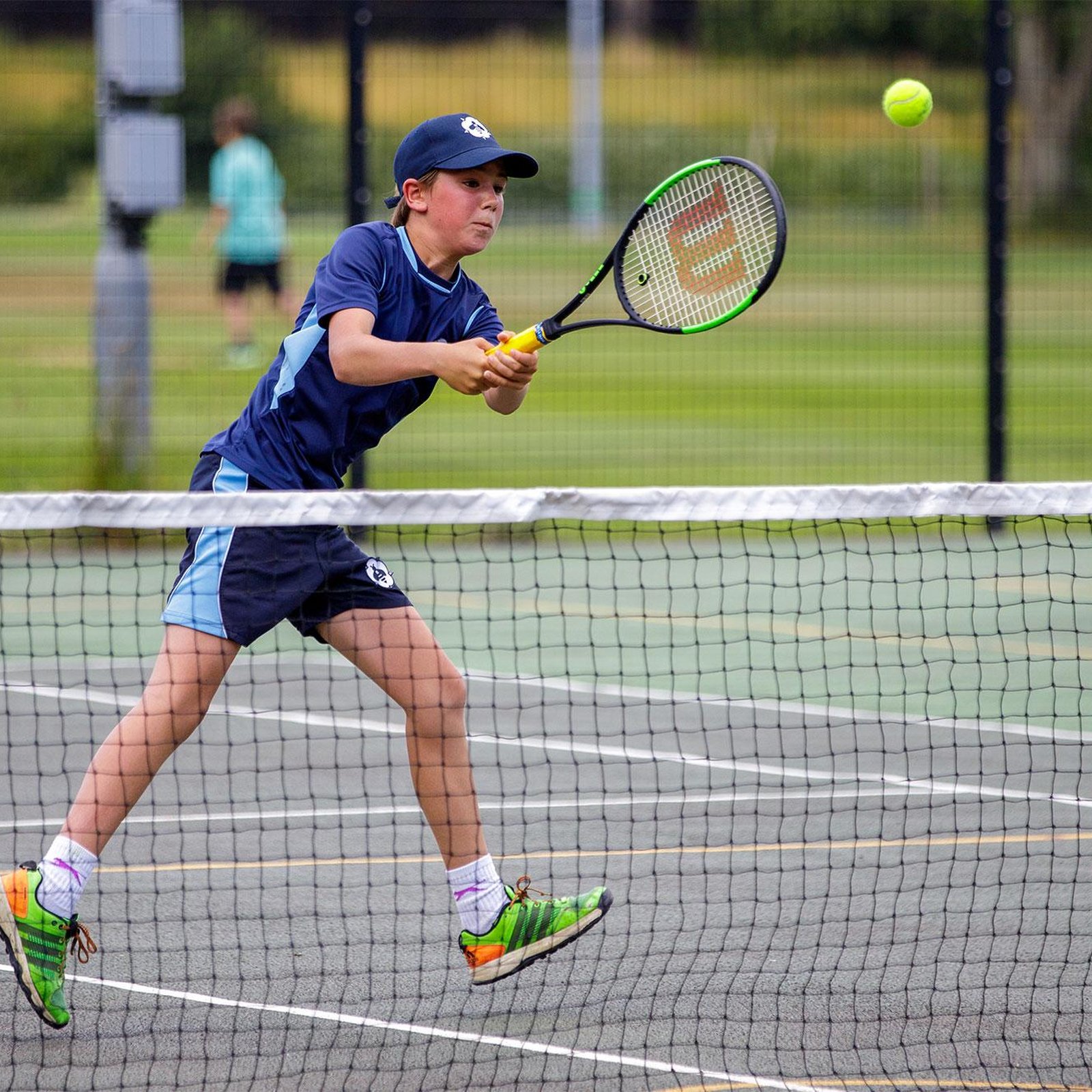 Bedales Prep student playing tennis on court