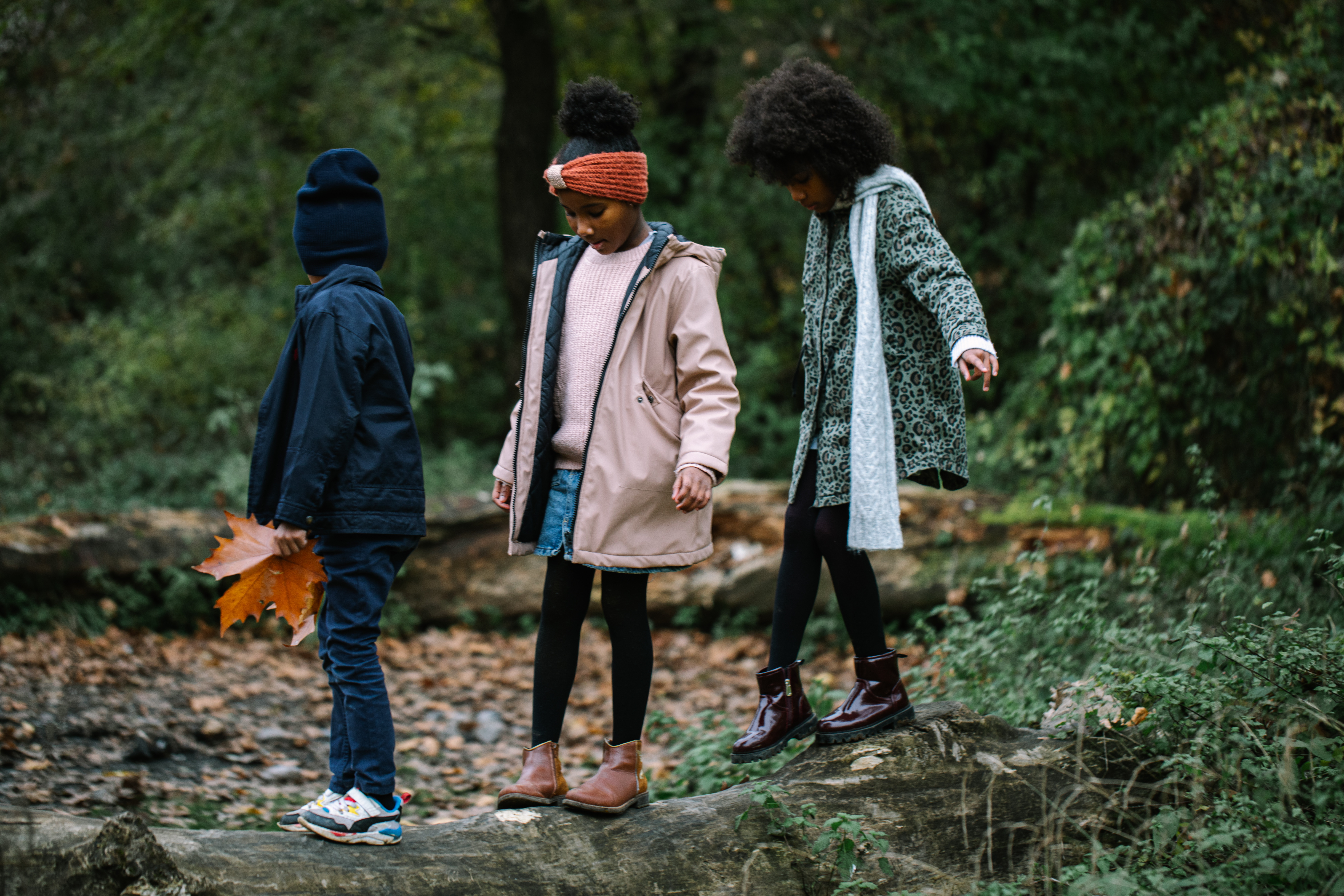 Kinderen buiten in het bos met kinderjassen aan