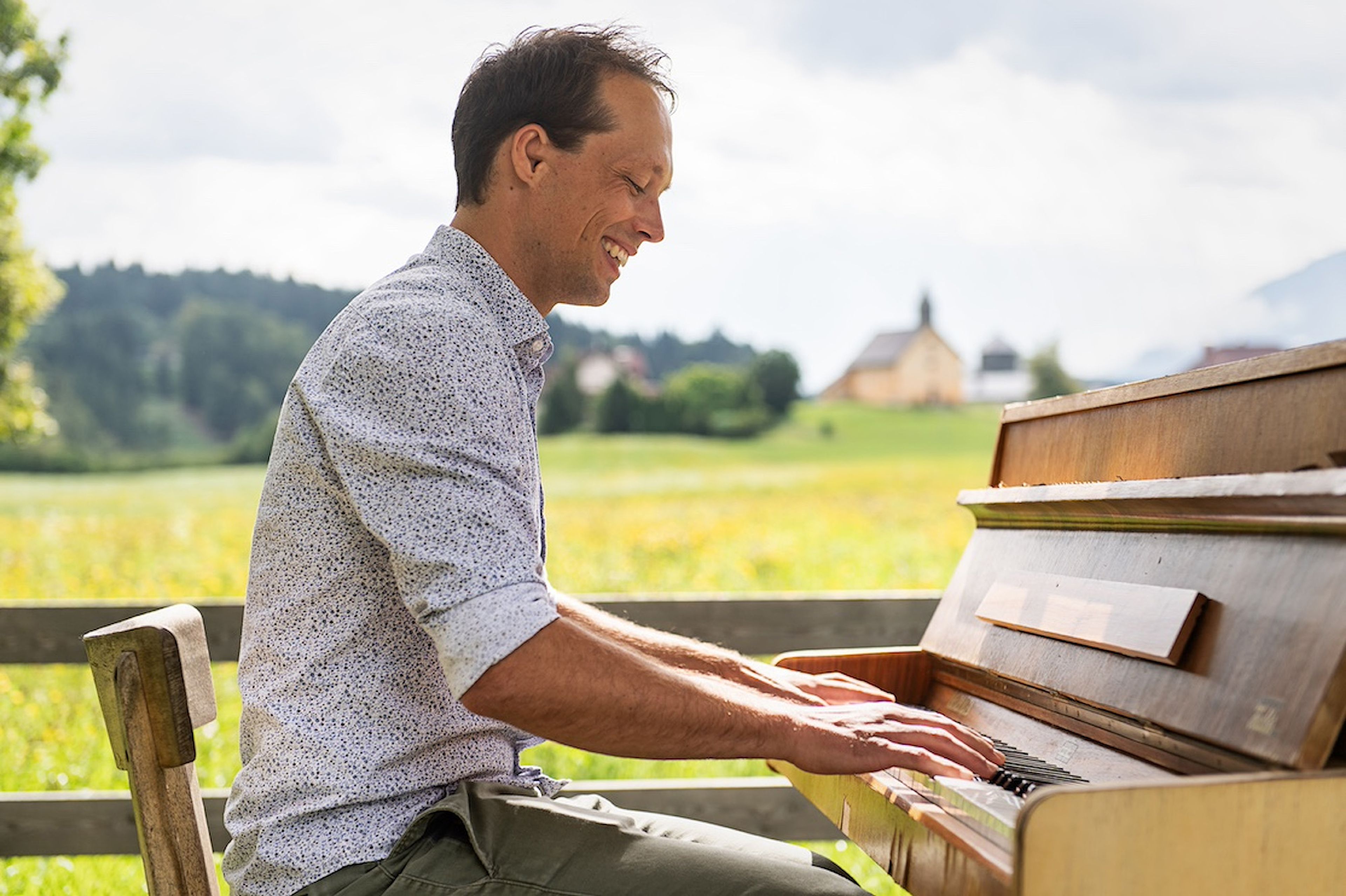 Johann Steinwender spielt draußen am Klavier