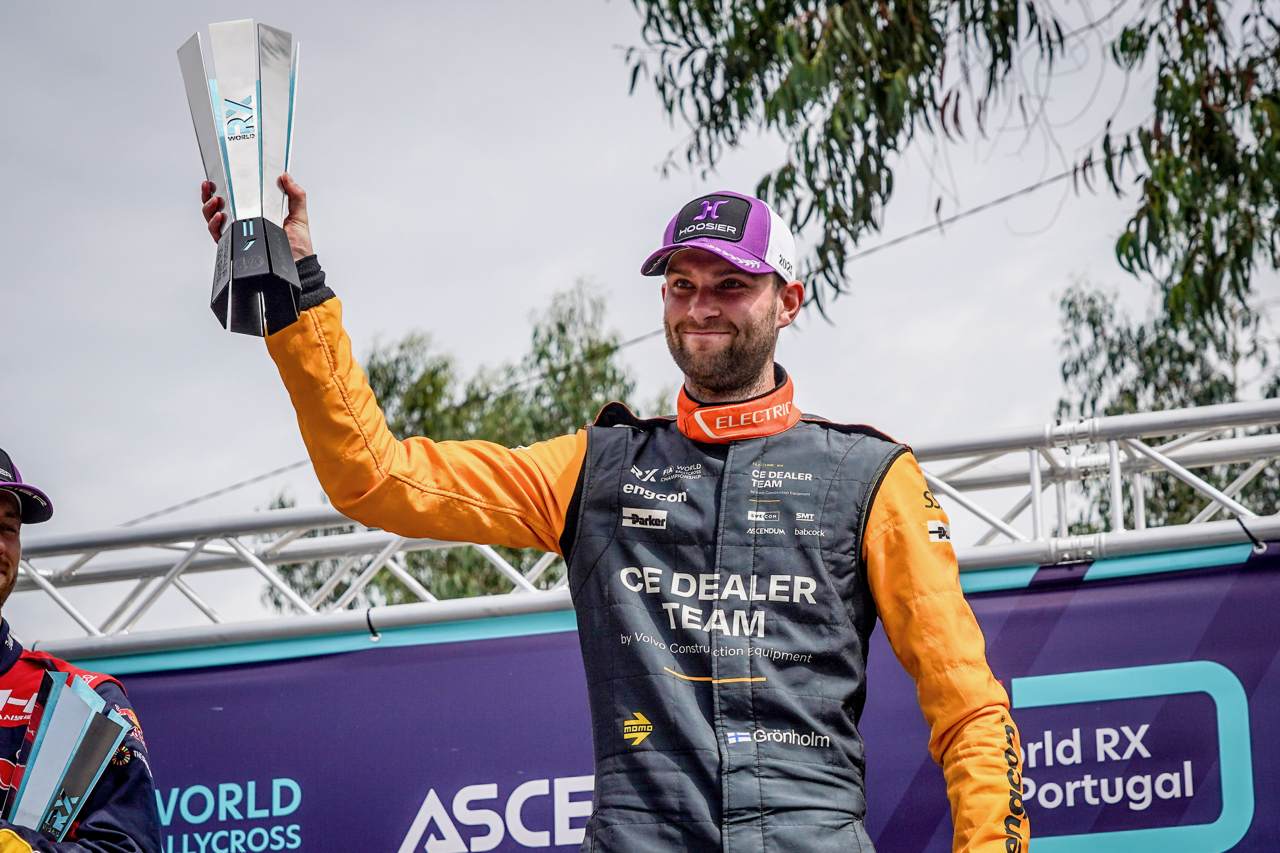 A man holding a trophy