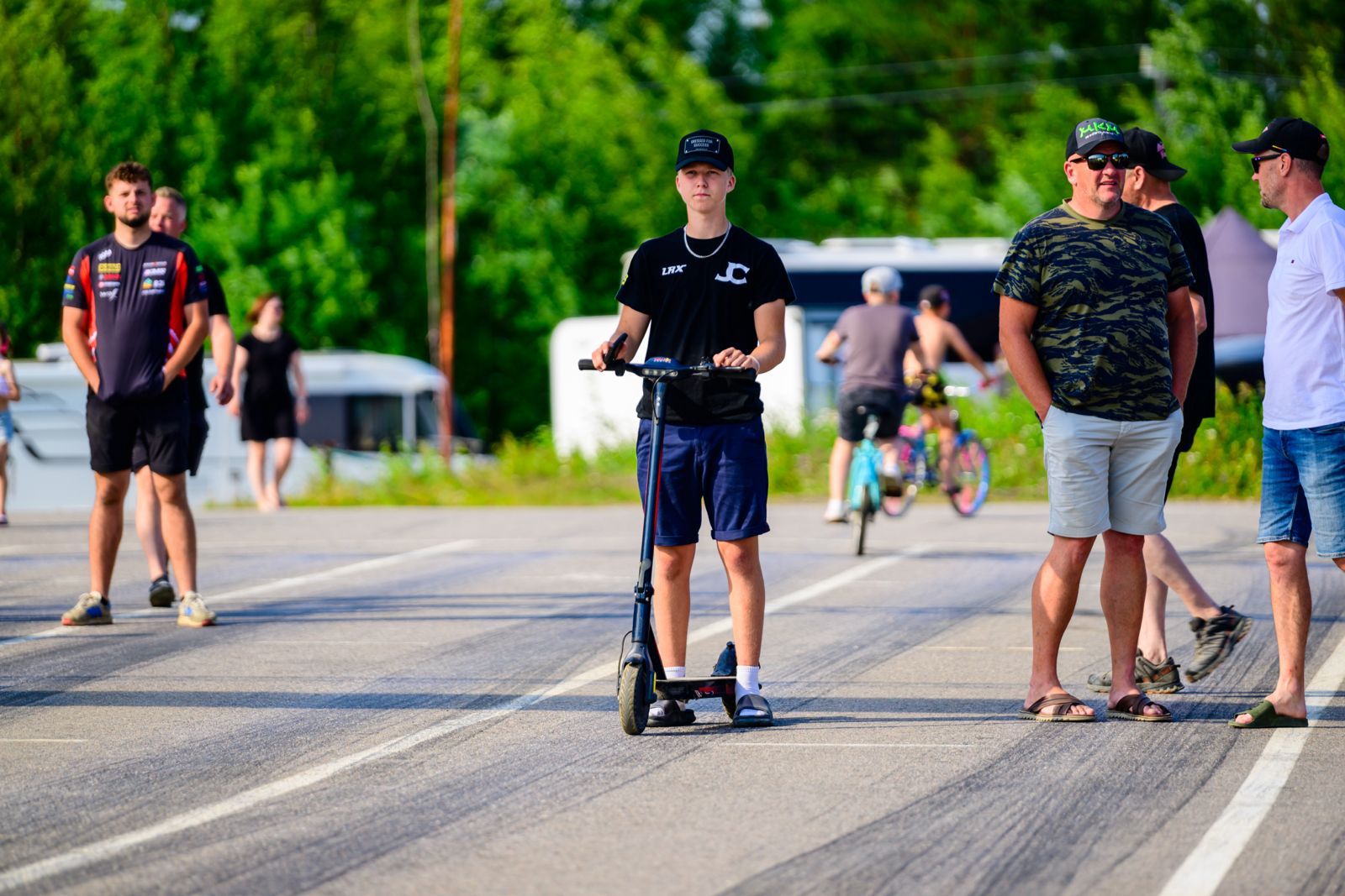 Man in cap on scooter on track