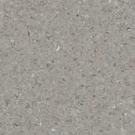 Close-up of a textured gray terrazzo surface with small chips in various shades of gray and white, creating a speckled pattern.
