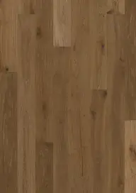 Wooden floor with a natural oak finish, featuring a smooth texture and visible grain patterns in various shades of brown.