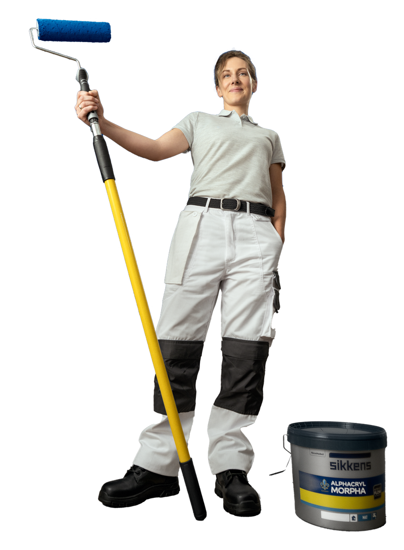 Person in work attire holding a paint roller with an extended handle.