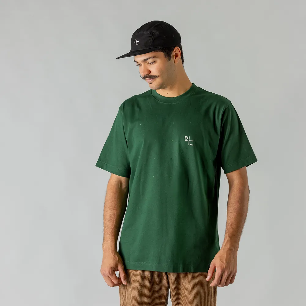 Mann in dunkelgrünem BIXS T-Shirt mit schwarzer Cap, Blick nach unten