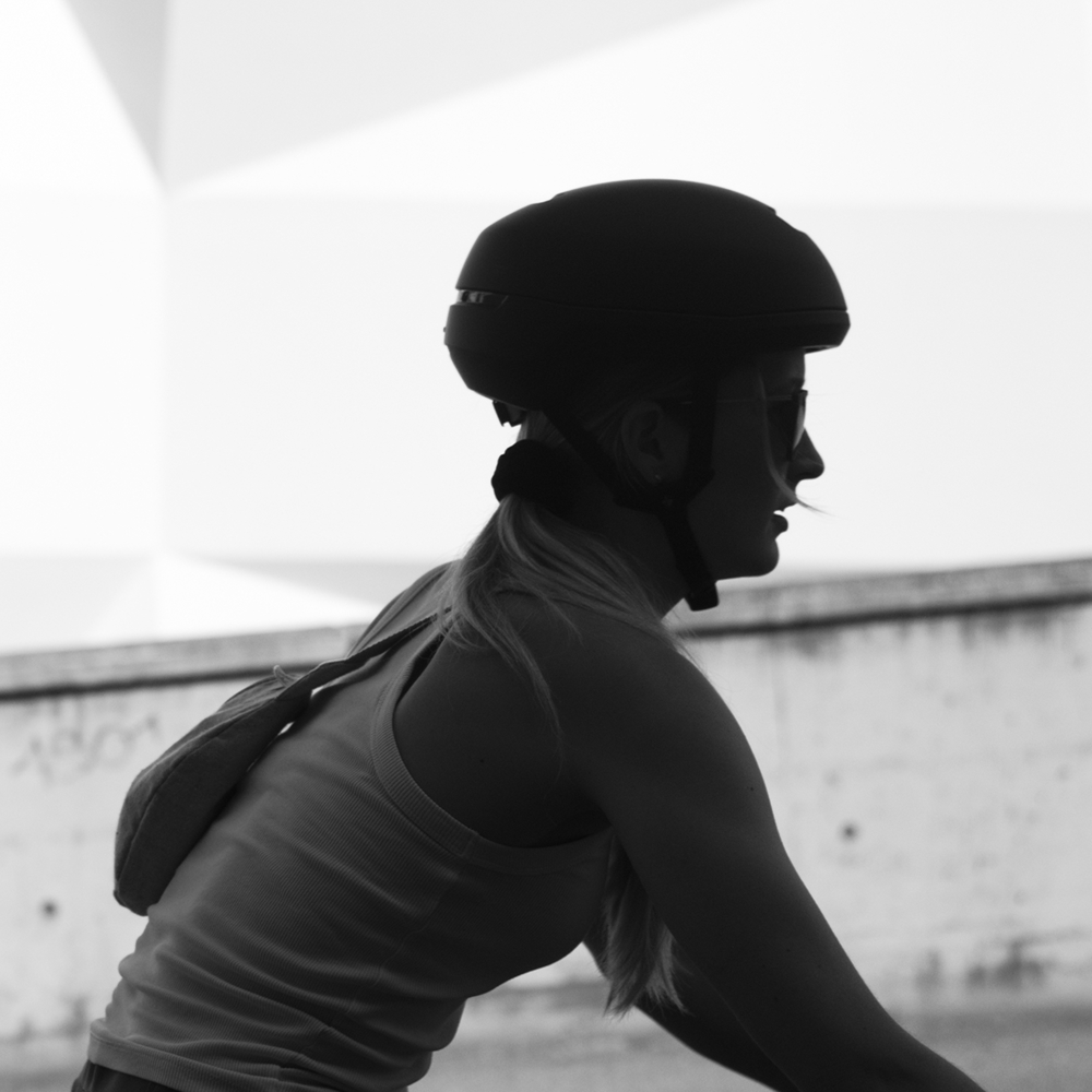 BIXS Mindsetter, im Profil auf dem Velo, Schwarz-weiss-Aufnahme mit Helm und Rucksack