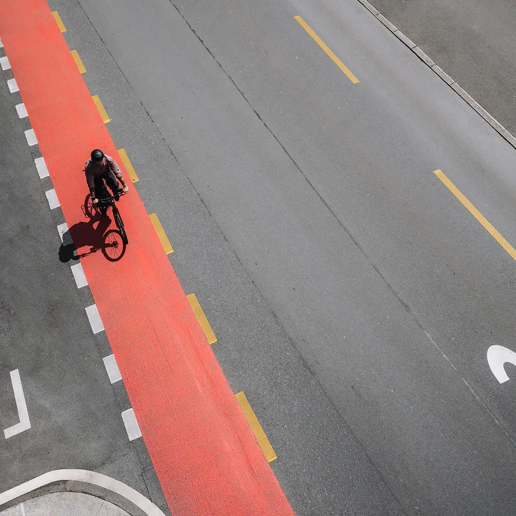 Luftaufnahme eines Fahrers auf rotem Velostreifen in der Stadt