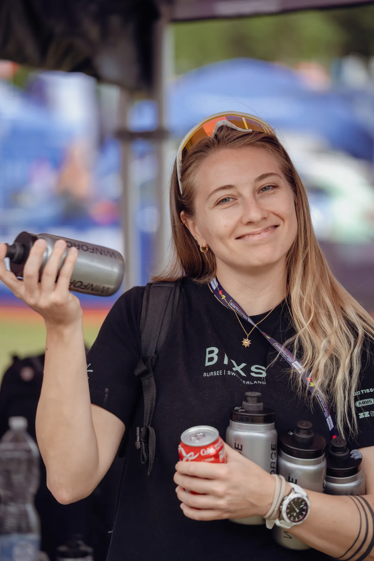 Seraina Schmid, Physiotherapeutin im BIXS Race Team, mit Trinkflaschen und Dose in der Hand