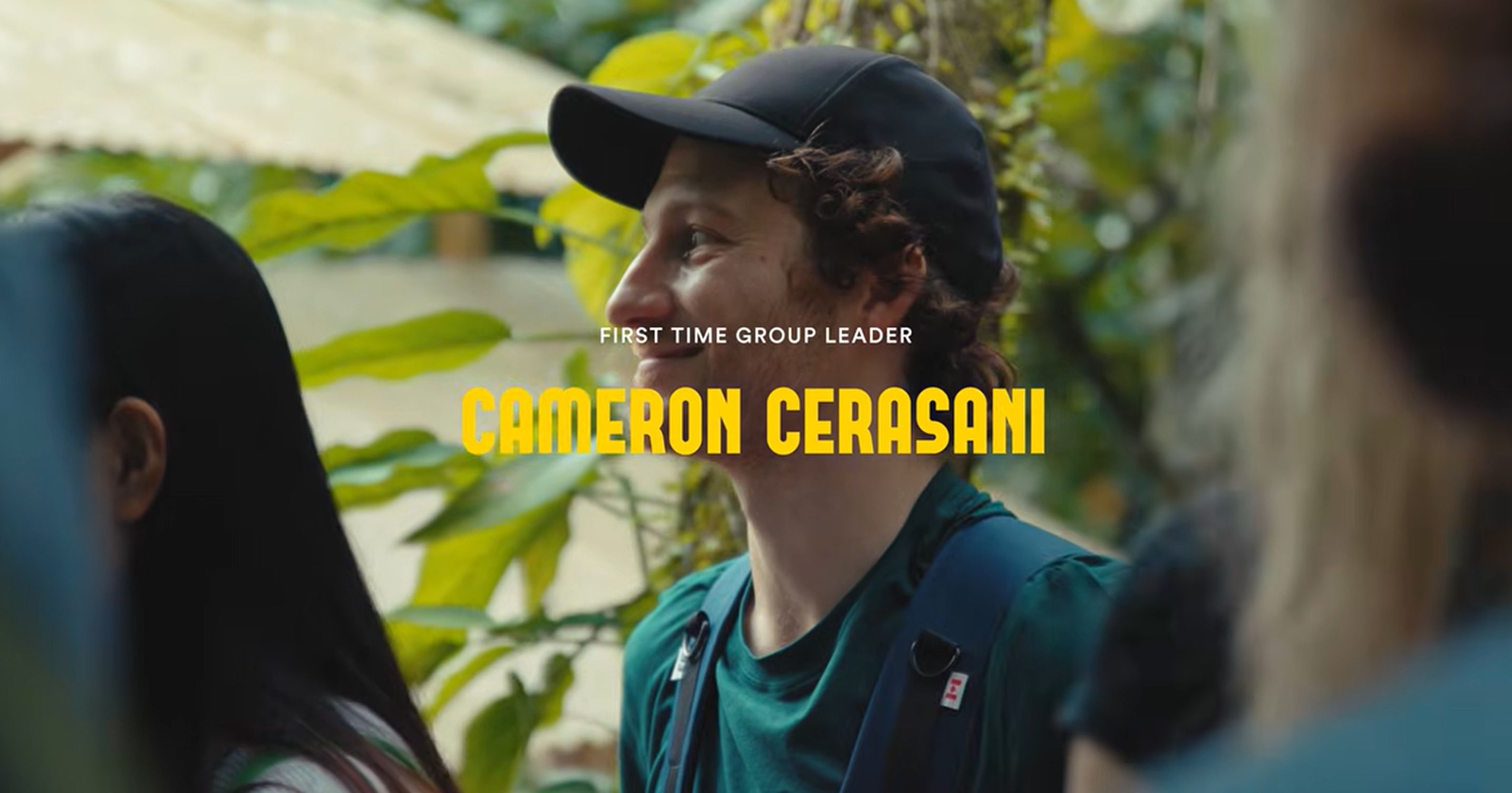 Video thumbnail of Cameron Cerasani, a first time group leader, smiling in profile in a dark cap and teal shirt among tropical plants in Costa Rica, with a play button over his name
