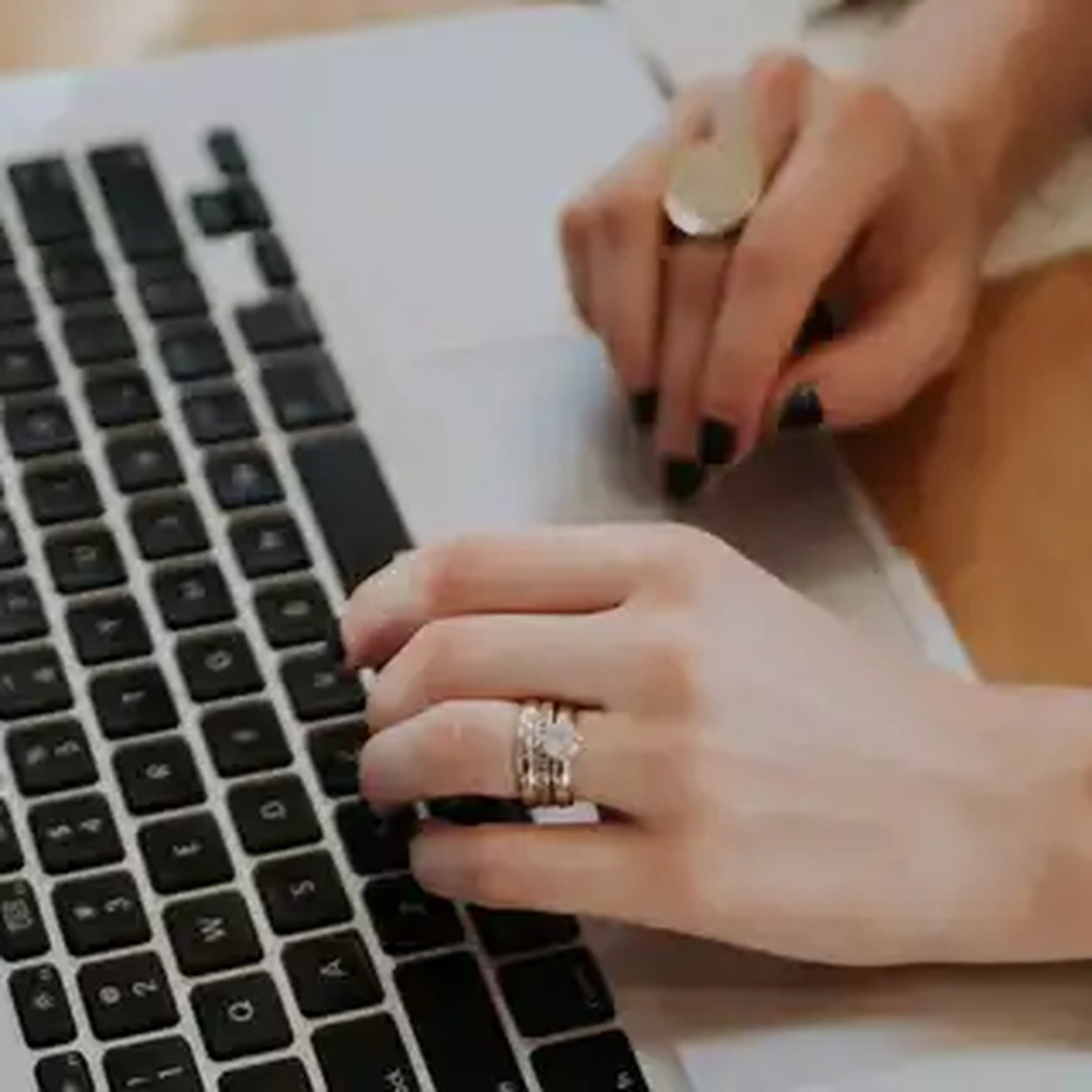 hands typing on a laptop