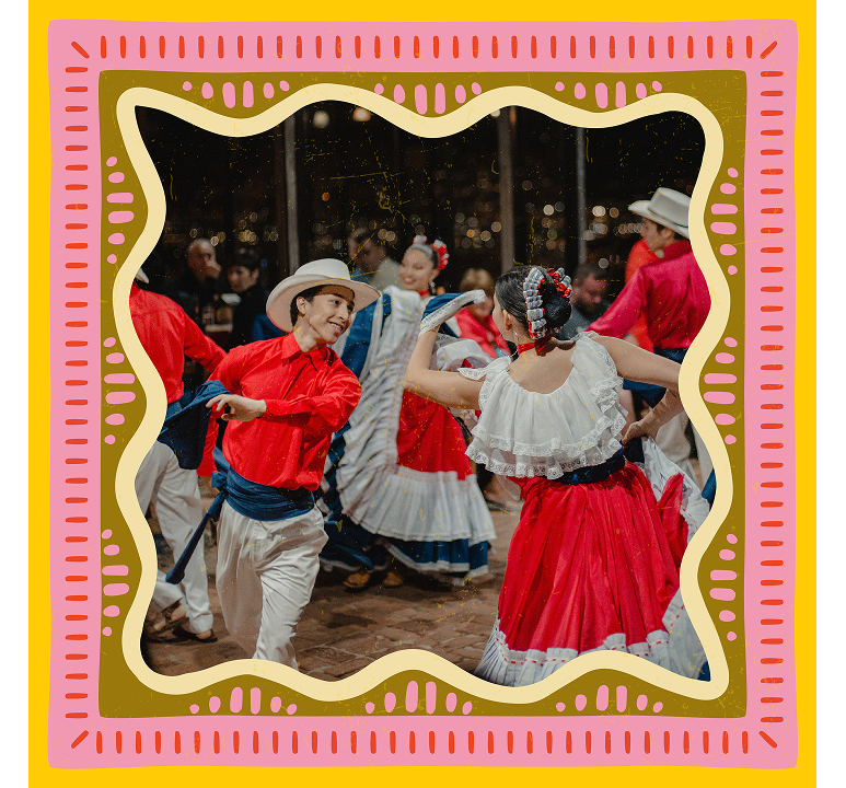 Dancers in red shirts, white hats and swirling red-and-white skirts performing a traditional Costa Rican folk dance on a patio at night