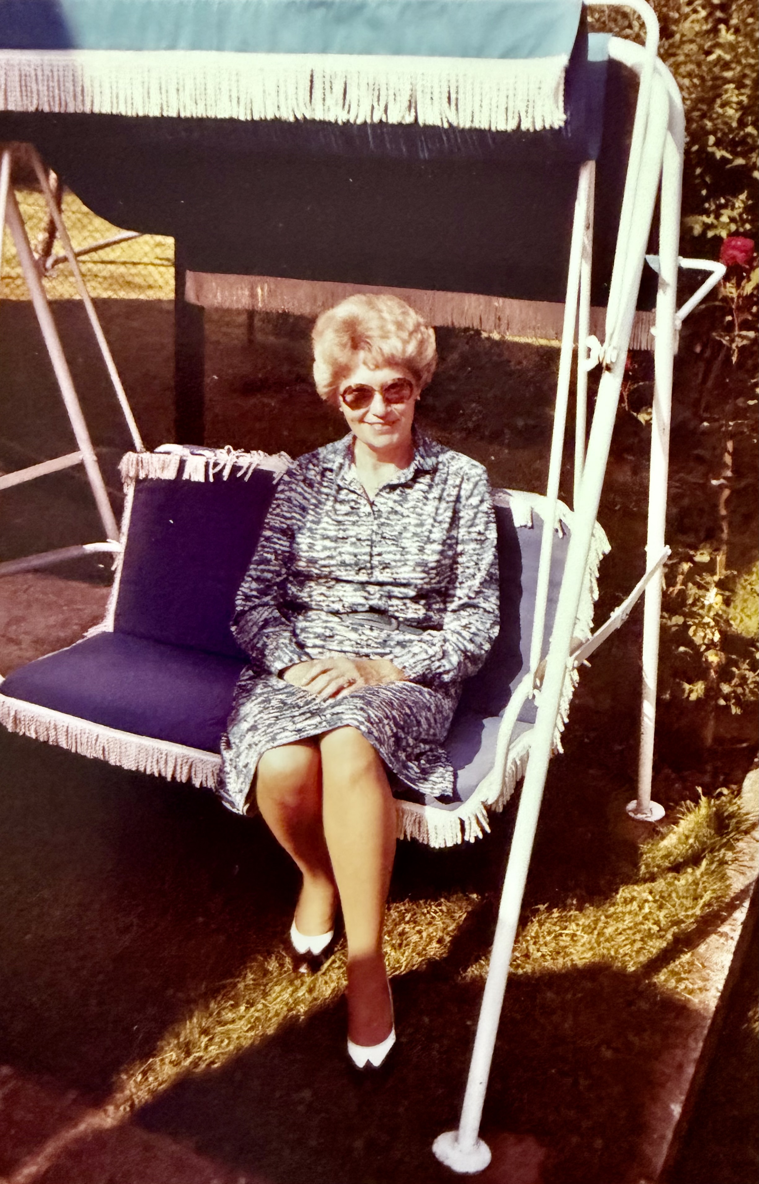 Anna Buraner in jüngeren Jahren sitzt auf einer Hollywoodschaukel