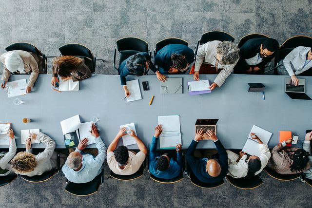 Aerial view of diverse businesspeople in a meeting around a table,