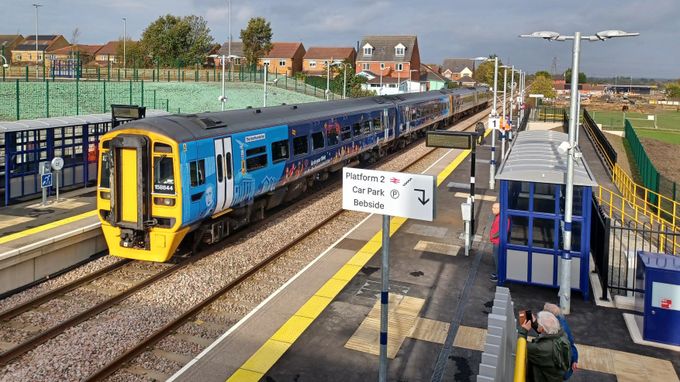 Northumberland line passenger train at a suburban station platform