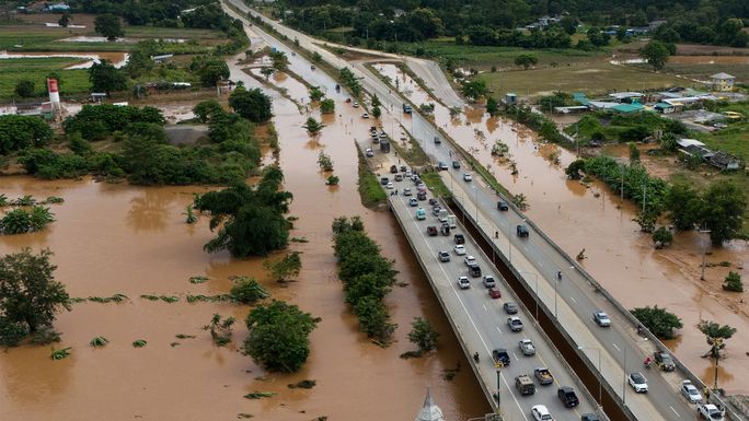 Aerial view of car driving on the bridge after road flooded during typhoon