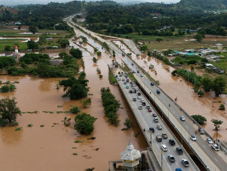 Aerial view of car driving on the bridge after road flooded during typhoon