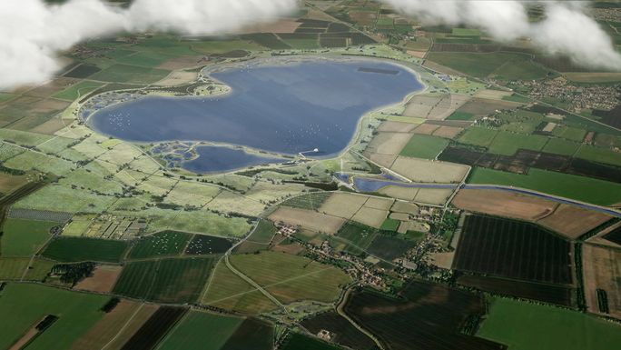 Aerial view of a large lake surrounded by patchwork fields. Paths and waterways crisscross the landscape.