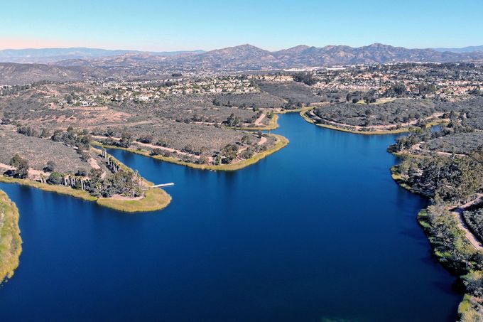 Aerial view of a reservoir surrounded by grassy peninsulas