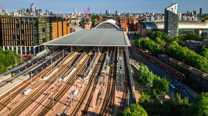 Aerial view of a St Pancras station with many tracks and platforms under a wide roof