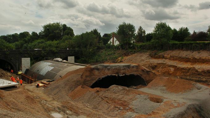 Workers from Network Rail survey the scene of tunnel collapse