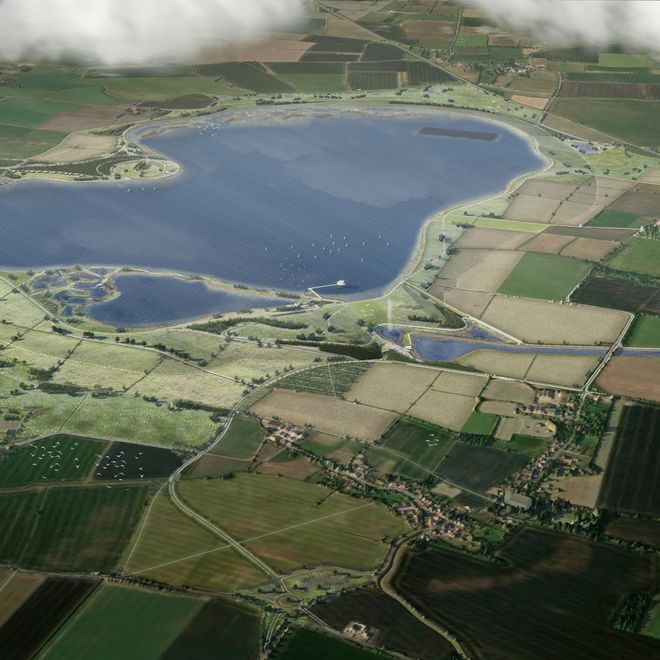 Aerial view of a large lake surrounded by patchwork farmland and small villages