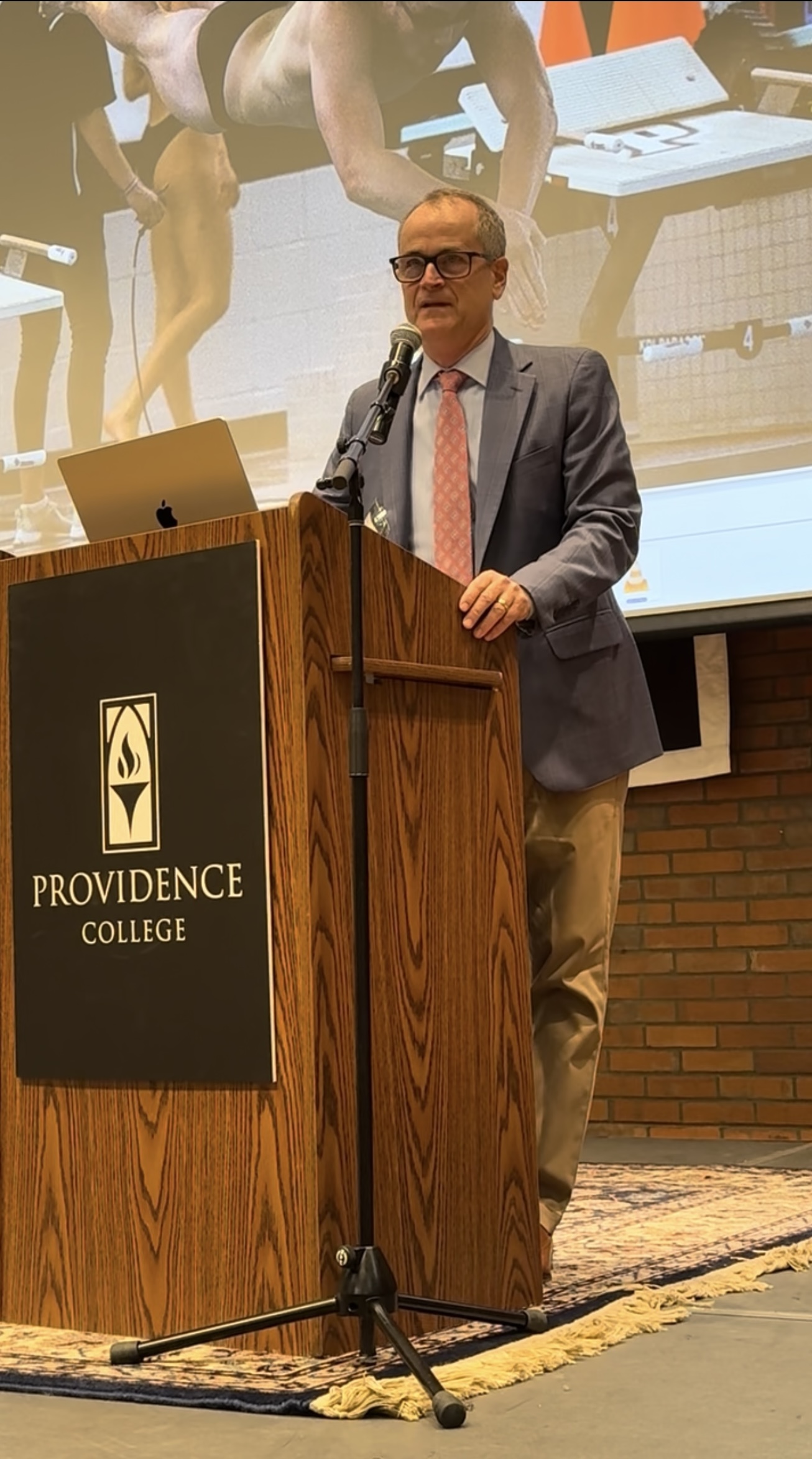 Attorney David Hardy speaking at a Providence College swimming event