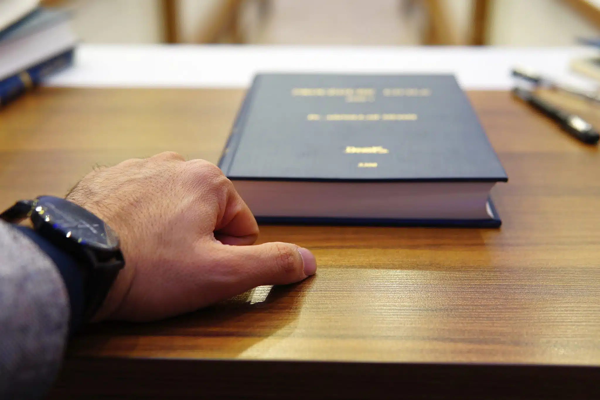 Hand resting near book