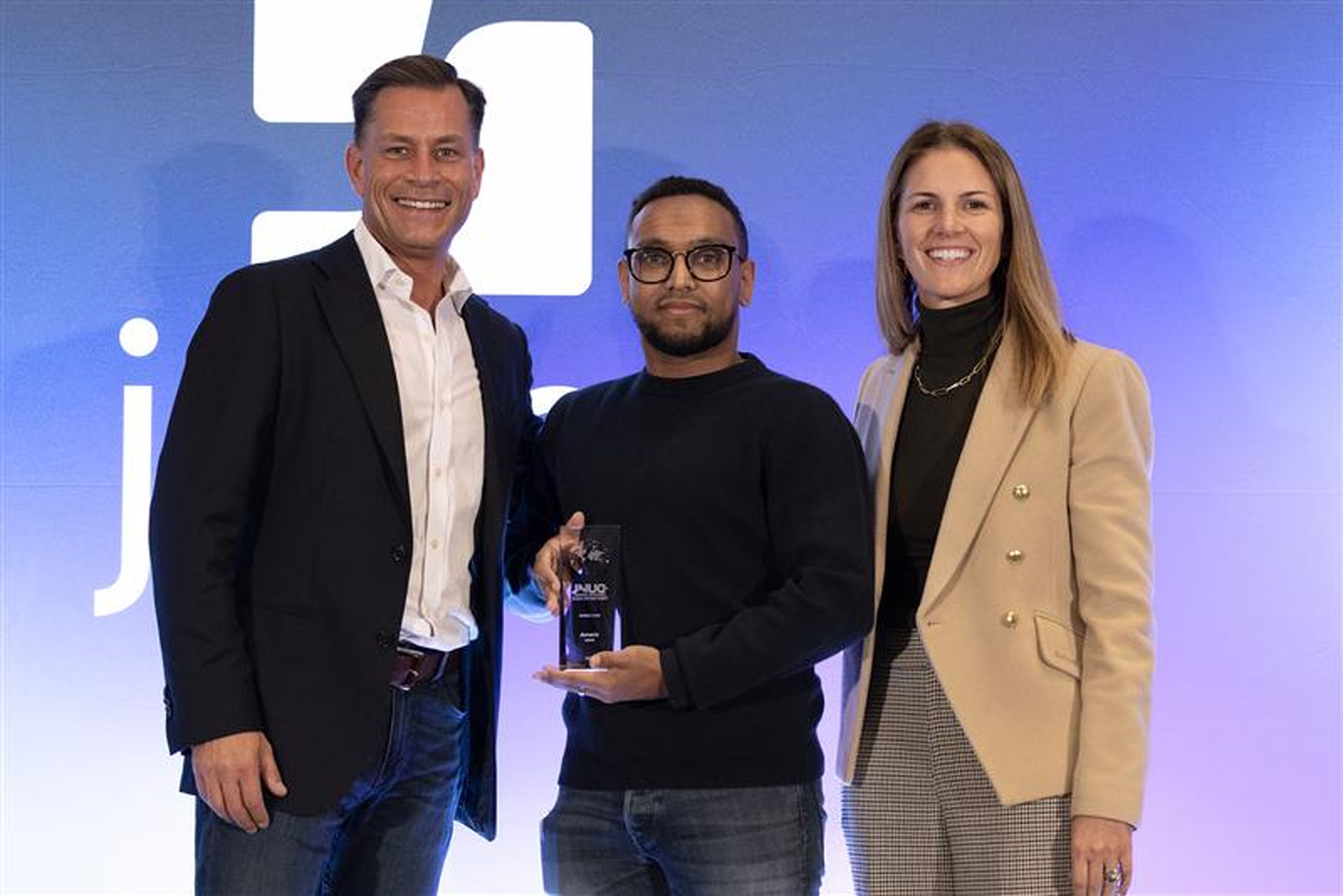 Team member from Amaris Consulting standing on stage at JNUC 2025 after receiving the Rising Star Award.