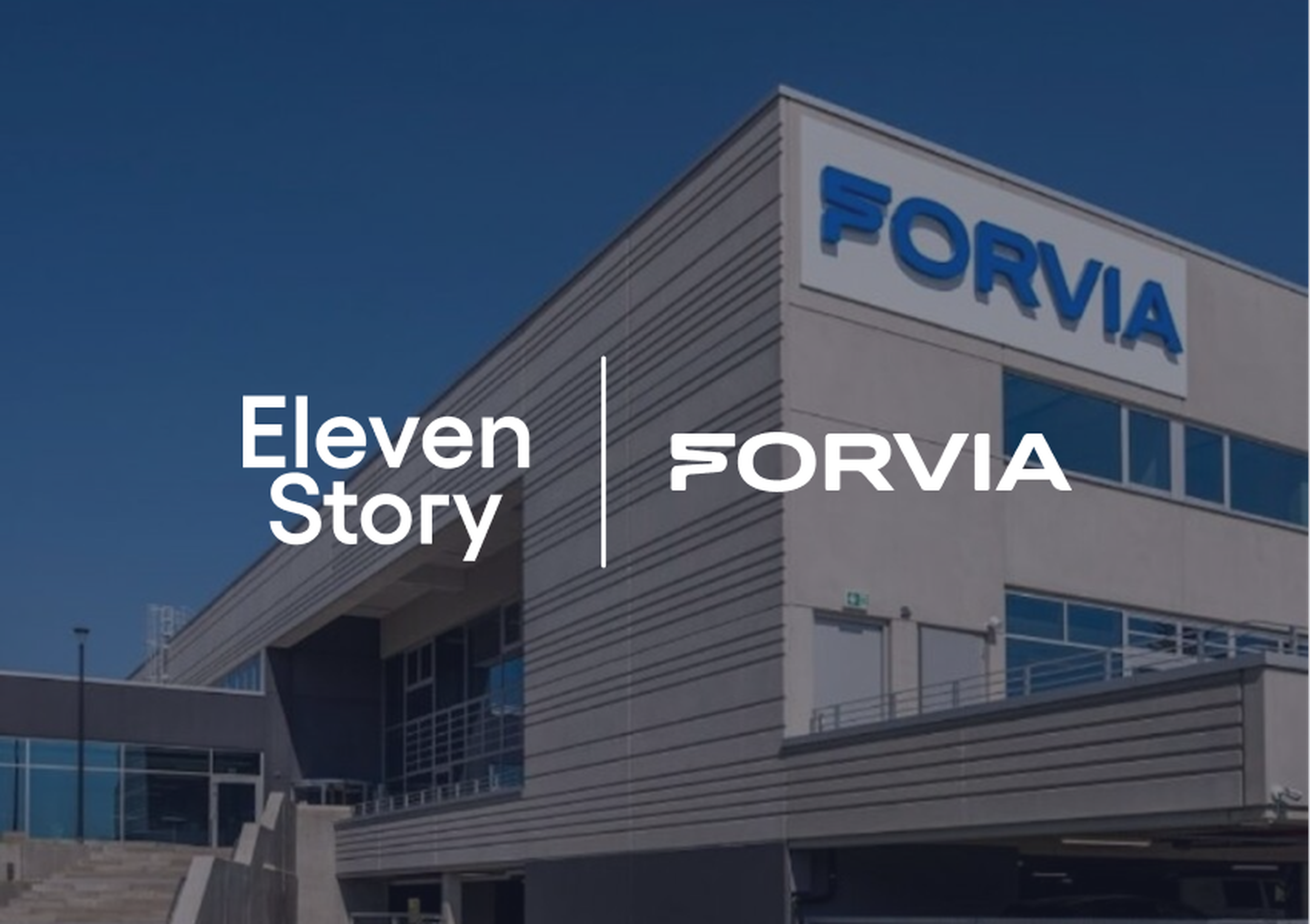 Modern building with "FORVIA" signage, featuring logos and text for "Eleven Story" and "FORVIA" against a clear blue sky.
