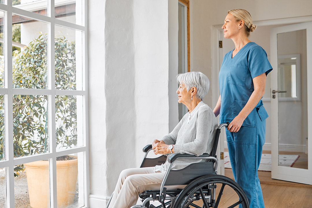 medical professional with elderly patient on wheelchair