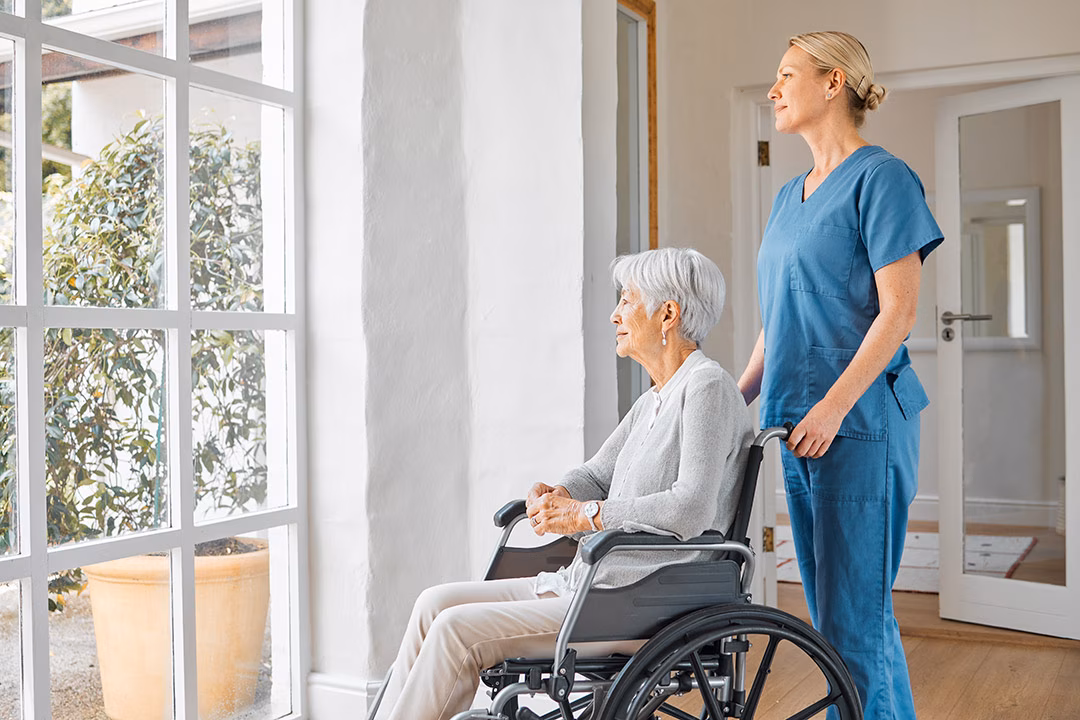 An elderly being assisted by a healthcare professional