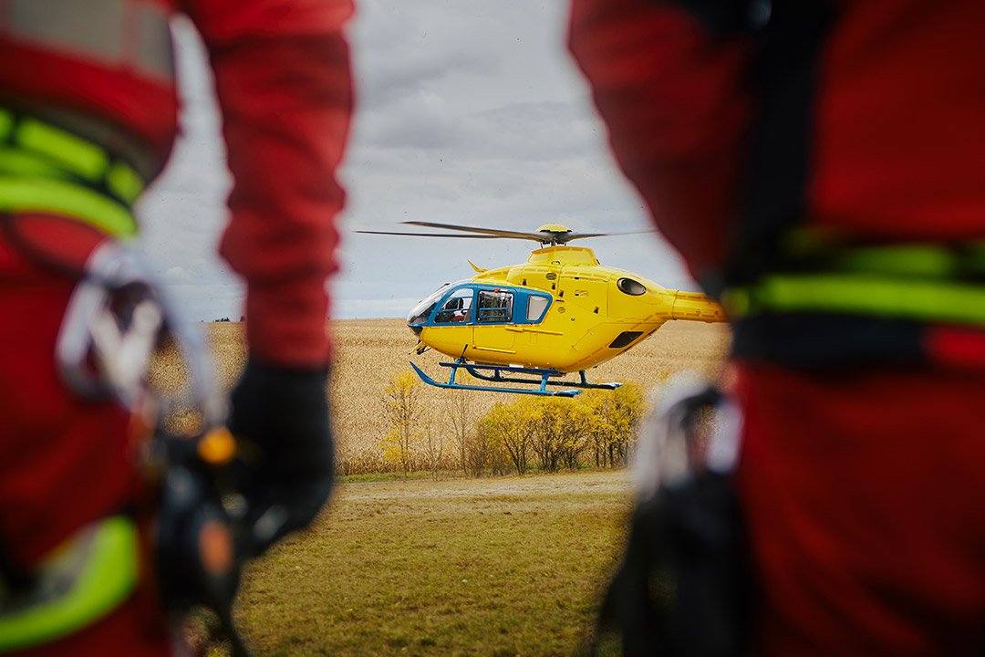 An ambulance helicopter landing in a field