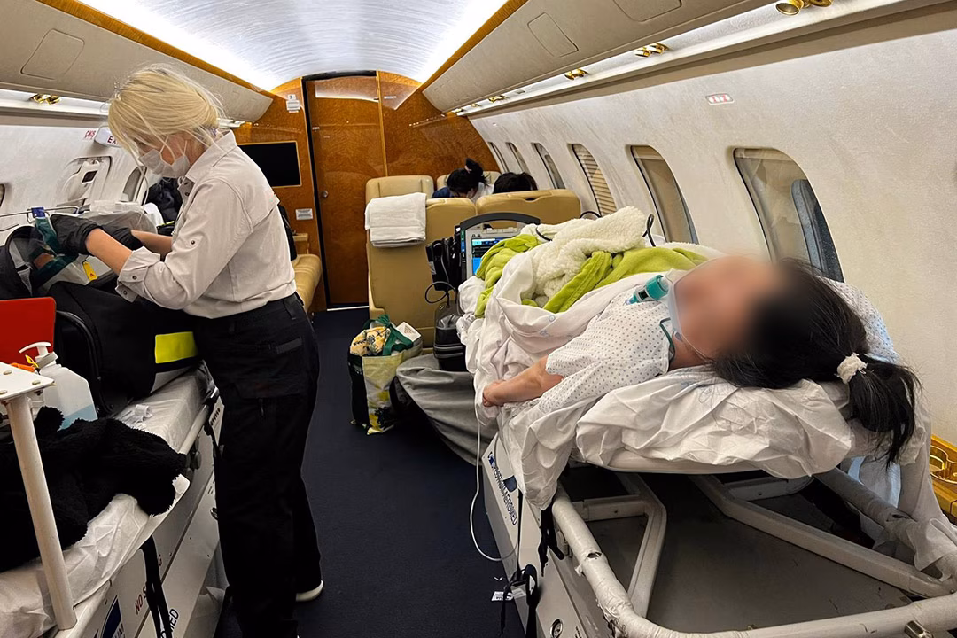A patient receiving medical assistance onboard an air ambulance