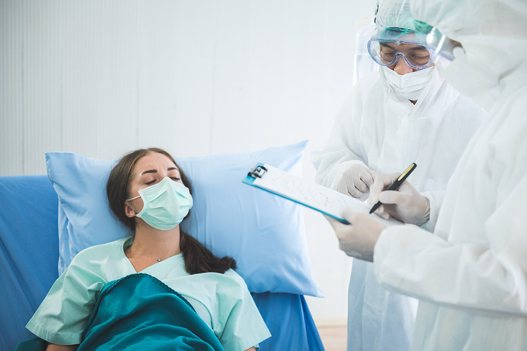 A contagious patient being treated by doctors